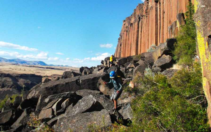 students make their way to a rock wall for climbing